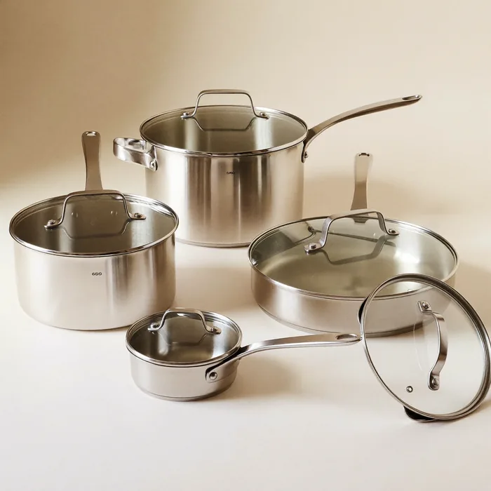 A matching set of stainless steel pots, saucepans and a casserole with glass lids